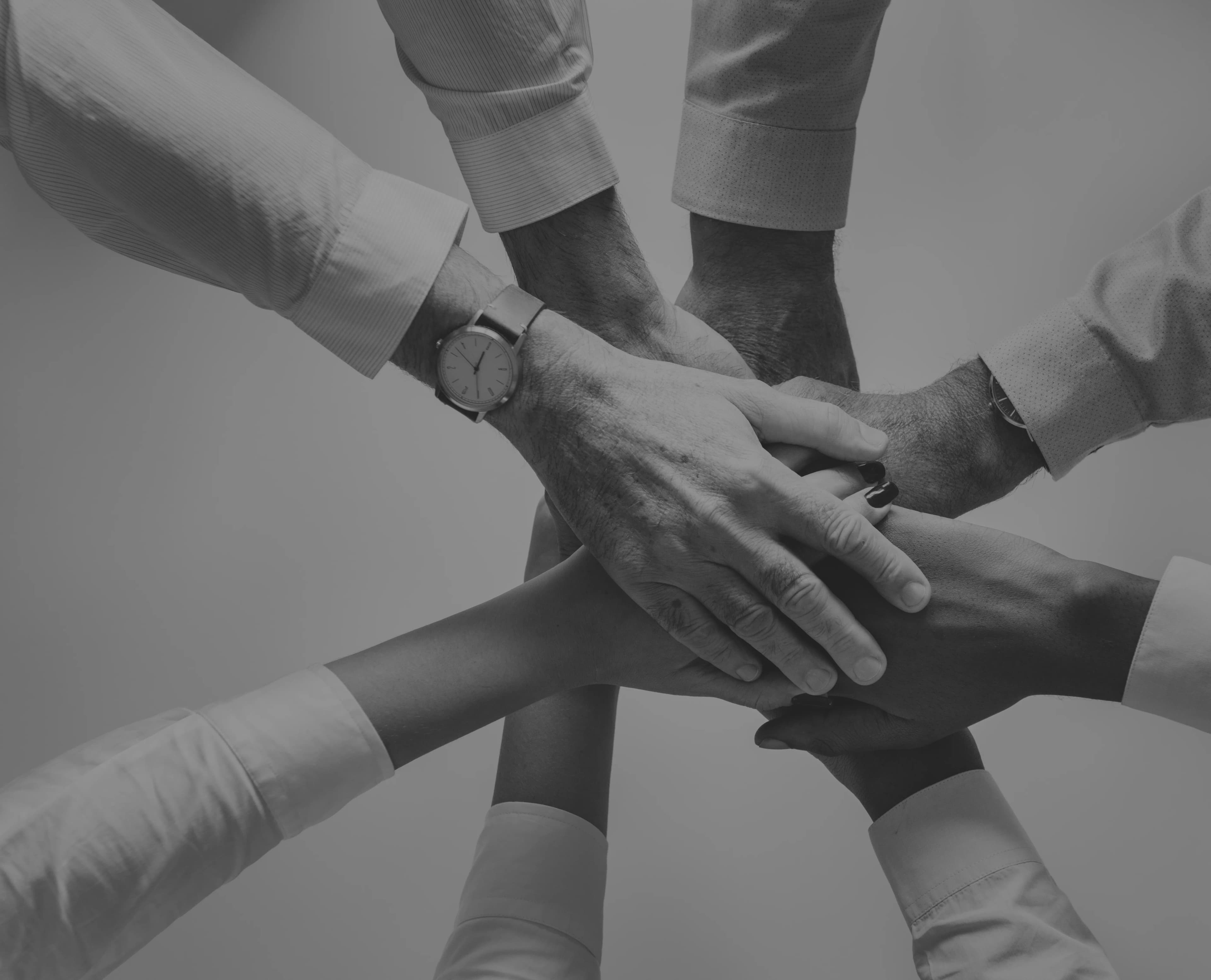 Manos de empresarios unidas simbolizando trabajo en equipo